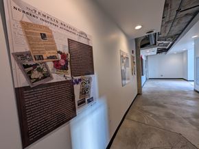 Cleveland apartment for rent - A wall of posters and pictures with a sign that says "The Templin Nursery Industry Automation".