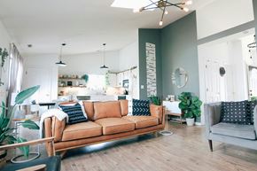 Dallas house for rent - A living room with a brown sofa and a grey armchair.