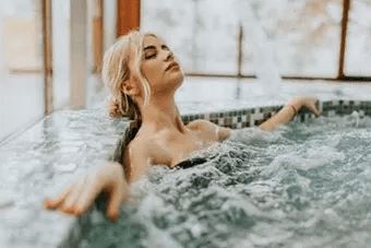 Woman is relaxing in a hot tub