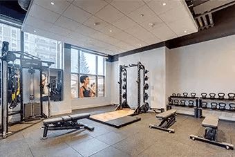 Gym with variety of equipment including a bench