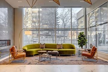 Edmonton apartment for rent - A living room with a green couch and a large window.