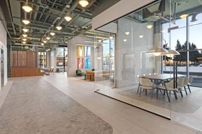 Ottawa apartment for rent - A modern office space with glass walls and a long table with chairs.
