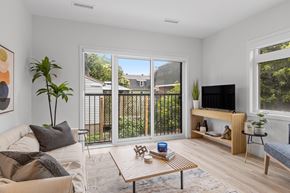 Ottawa apartment for rent - A living room with a couch, a coffee table, and a television.