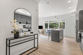 Ottawa apartment for rent - A modern kitchen with a large island and a fridge.