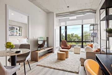 Ottawa apartment for rent - A modern living room with a dining table and chairs.