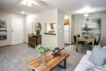 Lavista apartment for rent - A living room with a white couch, a wooden coffee table, and a painting on the wall.