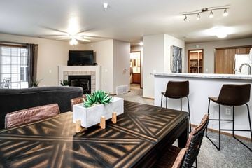 Omaha apartment for rent - A living room with a black and gold patterned table in the center.