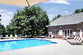 Omaha apartment for rent - A pool surrounded by chairs at Tranquility Pointe, Omaha, Nebraska