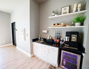 Great Falls apartment for rent - A kitchen with a black countertop and white cabinets.