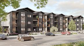 Great Falls apartment for rent - A row of modern apartment buildings with cars parked in front.