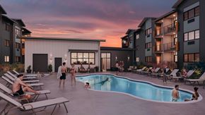 Great Falls apartment for rent - A group of people are enjoying the sun by the pool at a resort.