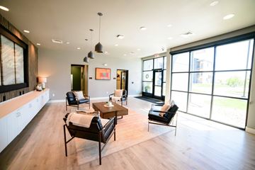 Great Falls apartment for rent - A living room with a brown chair and a brown table.