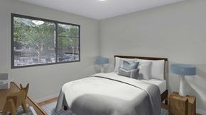 Bozeman apartment for rent - A bedroom with a large bed and a view of trees outside the window.