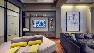 Frisco apartment for rent - A modern living room with a grey couch and a television.