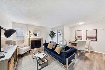 San Antonio apartment for rent - A living room with a blue couch and a fireplace.