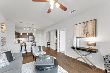 Forney apartment for rent - A modern living room with a grey sofa and a coffee table.