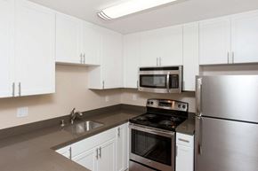 South San Francisco apartment for rent - a kitchen with white cabinets and stainless steel appliances