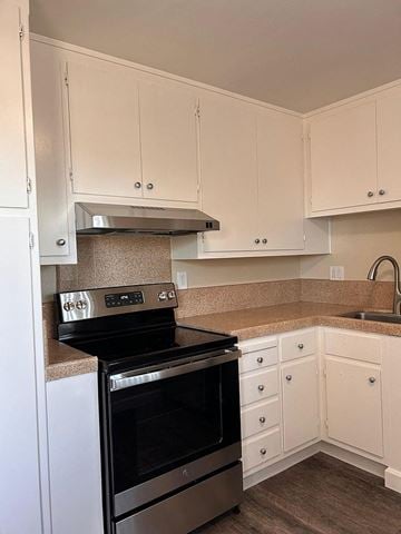 Burlingame apartment for rent - a kitchen with a stove and white cabinets