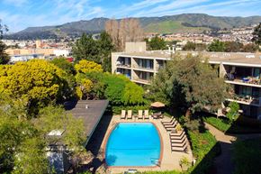South San Francisco apartment for rent - an aerial view of a swimming pool with a hotel in the background