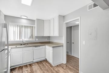 Sunnyvale apartment for rent - A kitchen with white cabinets and a refrigerator.