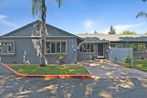 Menlo Park apartment for rent - A grey building with a red stripe on the driveway.