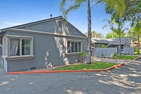 Menlo Park apartment for rent - A grey building with a red curb in front.