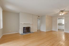 Menlo Park apartment for rent - A living room with a fireplace and a ceiling fan.