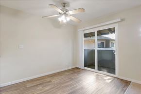 Menlo Park apartment for rent - A room with a ceiling fan and sliding glass doors.