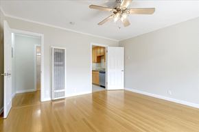 Menlo Park apartment for rent - A room with a ceiling fan and wooden floors.