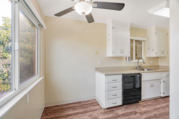 Mountain View apartment for rent - A kitchen with white cabinets and a black dishwasher.