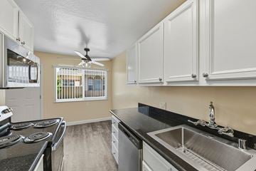 Campbell townhouse for rent - A kitchen with a stove top oven, sink, and cabinets.