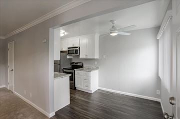 Mountain View apartment for rent - a kitchen with white cabinets and a stainless steel stove