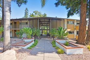 Menlo Park apartment for rent - a building with a courtyard with plants and trees