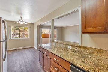 Sunnyvale apartment for rent - A kitchen with wooden cabinets and a marble countertop.
