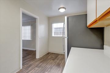 Menlo Park apartment for rent - a kitchen with a refrigerator and a door to a hallway