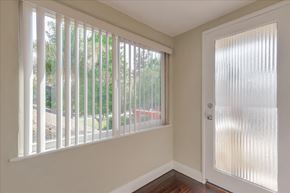 Menlo Park apartment for rent - a living room with a large window and a door with vertical blinds