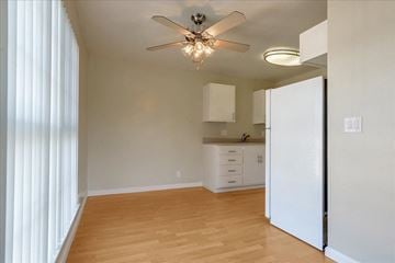 Redwood City apartment for rent - a kitchen with a white refrigerator and a ceiling fan