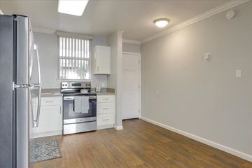 San Mateo apartment for rent - a kitchen with white cabinets and stainless steel appliances