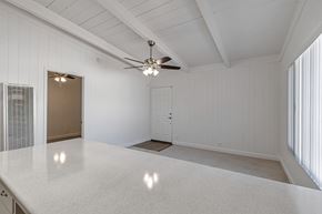 Mountain View apartment for rent - A spacious room with a ceiling fan and a large table.