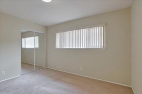 Menlo Park apartment for rent - a spacious living room with a large window and a mirrored closet