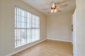 Redwood City apartment for rent - a living room with a large window and a ceiling fan