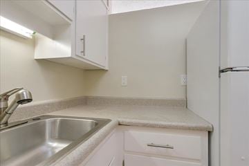 Redwood City apartment for rent - a kitchen with a sink and a refrigerator