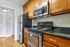 Menlo Park apartment for rent - A kitchen with a black refrigerator, stove, and oven.