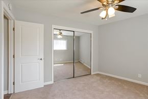 Redwood City apartment for rent - A room with a ceiling fan and a mirror on the wall.