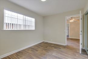 Menlo Park apartment for rent - a living room with a large window and a door to a hallway