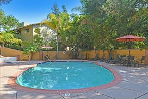 Menlo Park apartment for rent - A small pool surrounded by a red border and chairs.