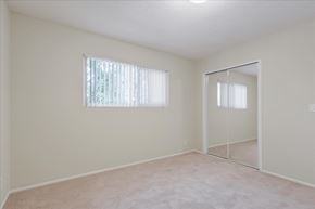 Menlo Park apartment for rent - an empty bedroom with a mirrored closet door and a window