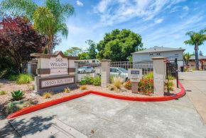Menlo Park apartment for rent - The image shows the entrance to the Willow Apartments with a sign and a red circular border.