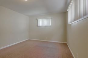 Menlo Park apartment for rent - A room with a carpeted floor and a window with blinds.