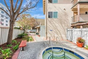 Burlingame apartment for rent - A small pool in a courtyard surrounded by a fence.